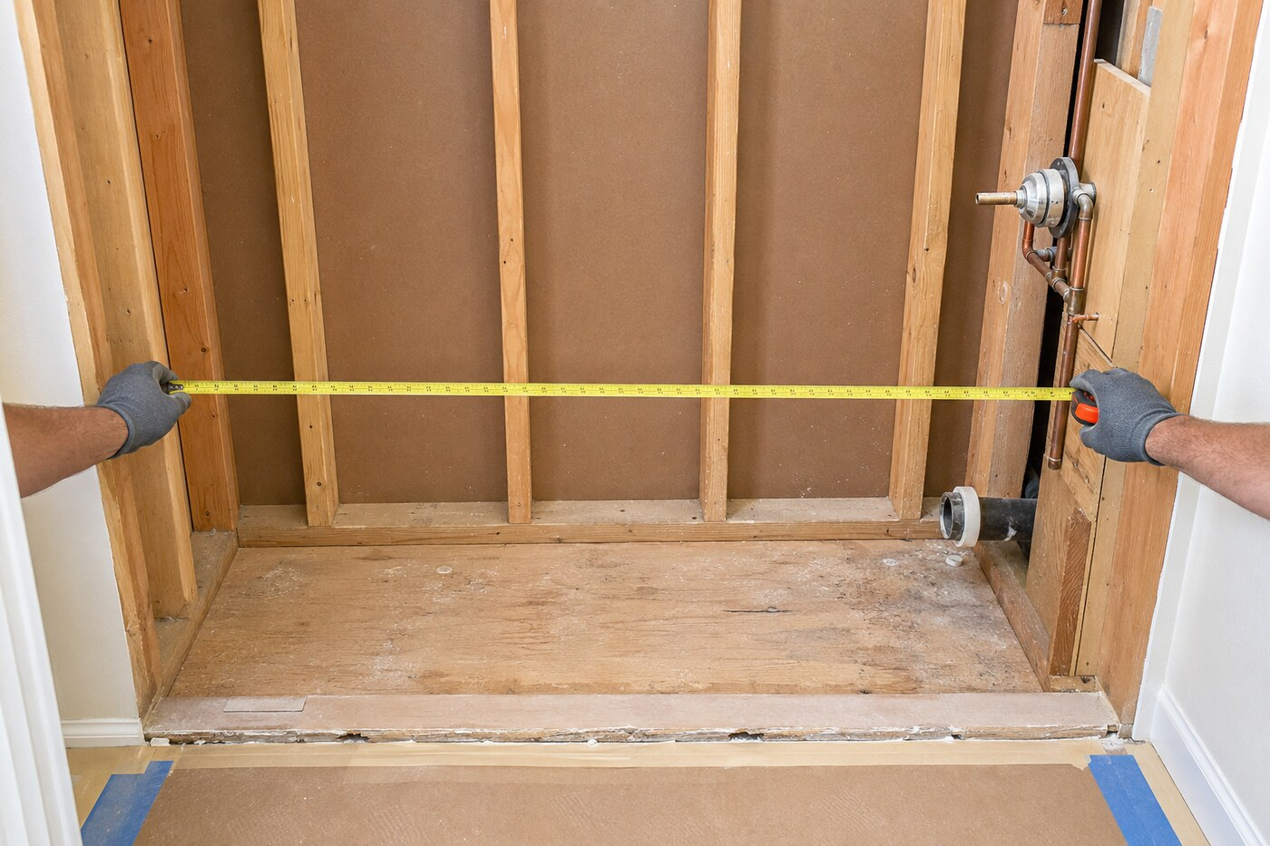 Bathtub replacement services in Denton TX measuring an open alcove with right-side plumbing